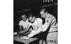 three men setting type